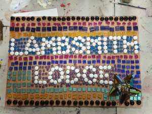 An image of a mosaic sign, still to be glued and grouted.  Sign Says: Lambsmith Lodge
